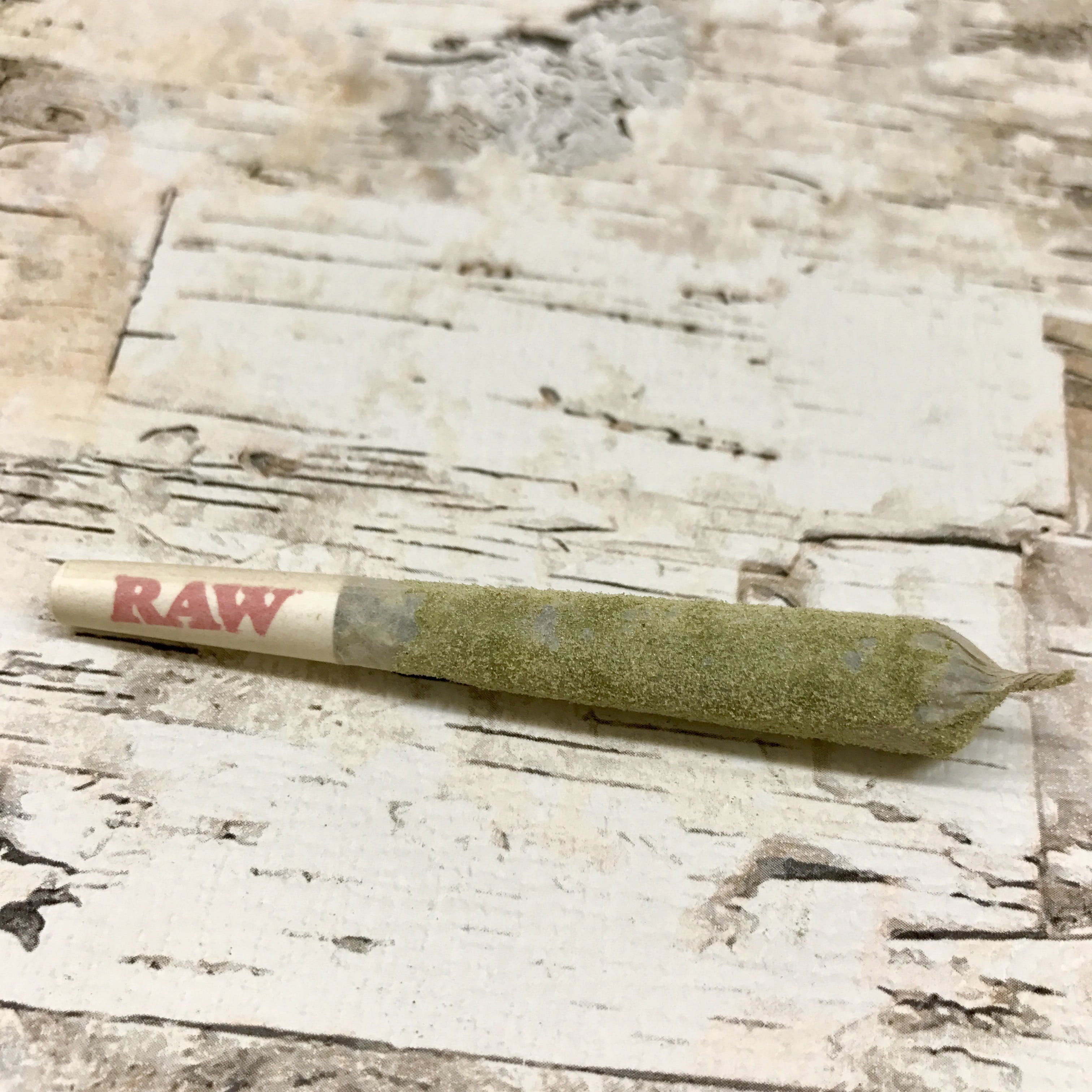 Flo OG joint painted with distillate and rolled in Kief